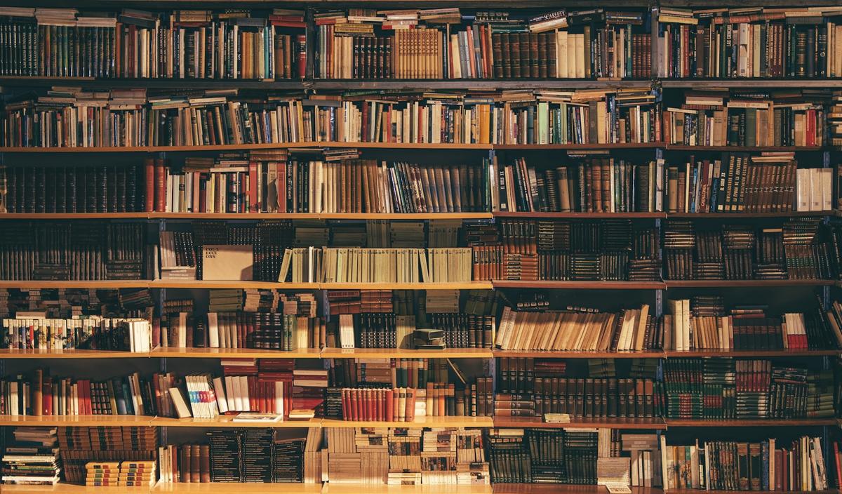 Floor-to-ceiling archival shelving holding decades of bound records
