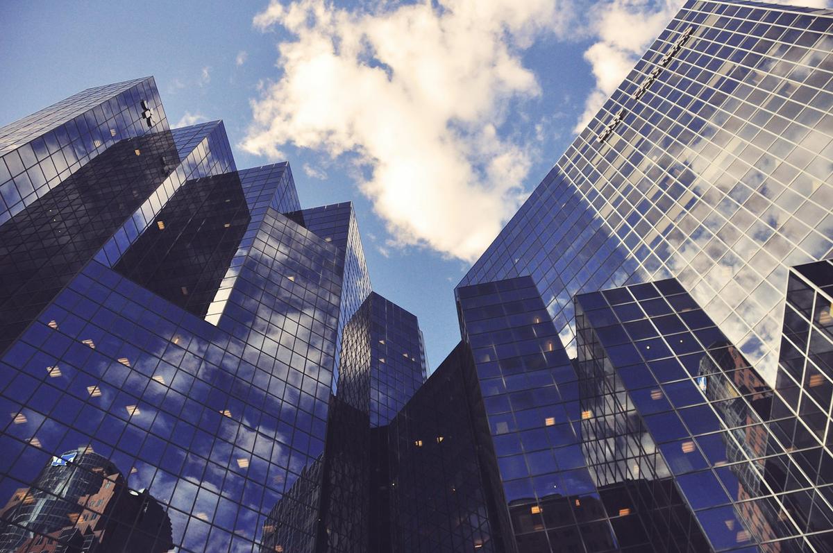 Glass office towers reflecting the sky